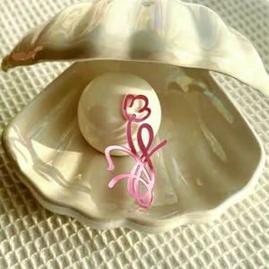 Charming pink acrylic flower cake topper featuring a lovely floral design for celebrations.