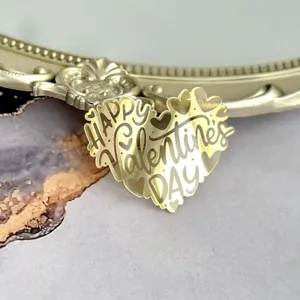Gold mirror acrylic heart cake topper detail shot showcasing festive Valentine text design.