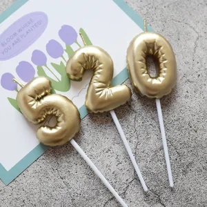 Gold number 520 cake candles with white sticks, perfect for birthday and anniversary party decor.