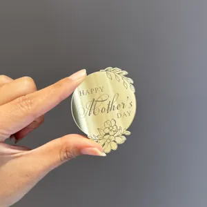 Gold mirror acrylic Happy Mother's Day cake topper detail shot with floral engraving.