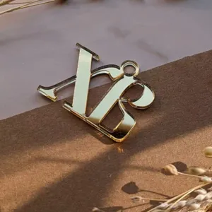 Gold mirror acrylic letter charm detail, custom monogram pendant with glossy finish.