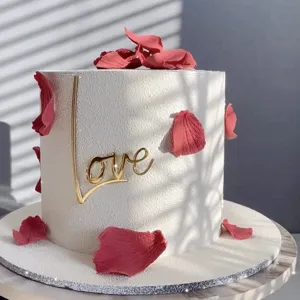 Elegant gold acrylic Love cake topper for Valentine's Day wedding party celebration.