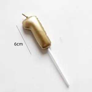 Detail view of gold balloon number one birthday cake candle topper, elegant party decoration.