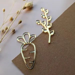 Gold acrylic carrot and branch cake topper detail view, premium decoration accessory.
