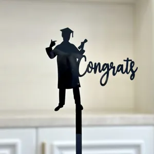 Black acrylic graduation cake topper with Congrats lettering for graduation party decorations.