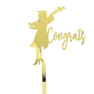 Gold acrylic graduation cake topper with congrats silhouette design for party decoration detail.