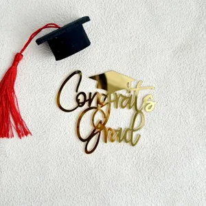 Graduation cake topper set featuring gold acrylic Congrats Grad text and mini cap.