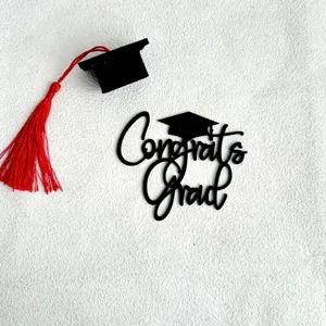 Black acrylic graduation cake topper set with mini doctor hat for graduation party decor.