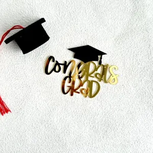Black and gold acrylic graduation cake topper set with mini cap for graduation party decor.