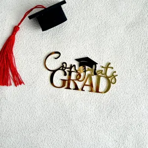 Gold acrylic Congrats Grad cake topper detail with black graduation cap and red tassel.