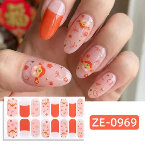 Festive New Year nail wraps featuring cute cartoon lion and shimmering gold star accents.