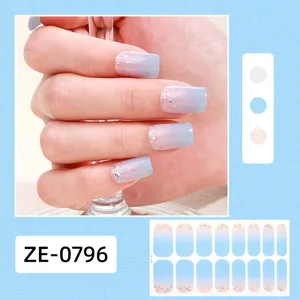 Detailed view of gradient glitter nail wraps on hand, sparkling blue pink design sticker.