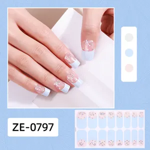 Detail view of the French style glitter nail wrap stickers showing hand wear effect and sheet.