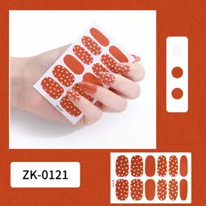 Orange polka dot nail stickers detail view, showing glossy texture and cute pattern style.