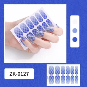 Close-up detail of blue gradient plaid nail stickers with glitter finish, hand wear display.