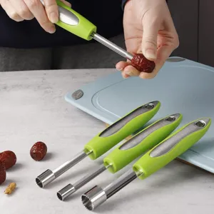 Stainless steel red date corer fruit pit remover tool with green handle detail view