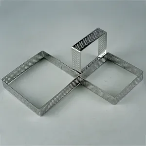 Detail shot of perforated stainless steel square tart ring for baking French desserts.