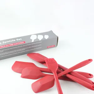 Silicone kitchen spatula set detail showing red heat-resistant baking tools and utensils.