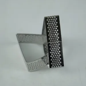 Detail shot of perforated stainless steel tart ring and pastry baking mold with clean finish.