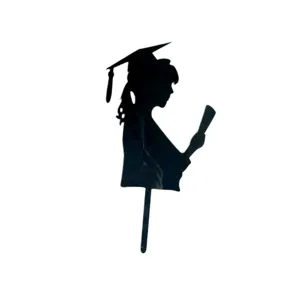 Close-up detail of black acrylic graduation cake topper silhouette with cap and diploma.