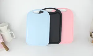 Detail view of multi-color plastic cutting boards set, anti-slip kitchen tool in blue black pink.