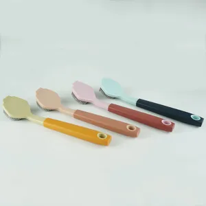 Close-up detail of multi-color long handle cleaning brushes for kitchen pots and dishes.