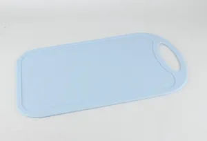 Detailed view of a light blue plastic cutting board with convenient handle hole design.