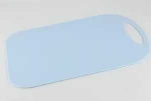 Blue plastic cutting board detail showing the smooth surface, rounded corners and hanging hole.