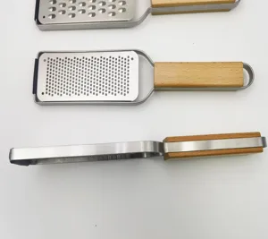 Stainless steel cheese grater with wooden handle, perfect for lemon zesting and chocolate.
