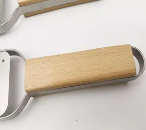 Stainless steel cheese grater with wooden handle detail view for kitchen cooking tool