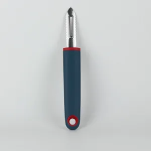 Stainless steel kitchen peeler close-up showing sharp blade and ergonomic handle design.