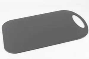 Detailed close-up view of the black plastic cutting board featuring a hanging hole.