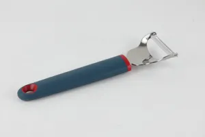 Stainless steel kitchen vegetable peeler detail with ergonomic silicone handle for cooking.