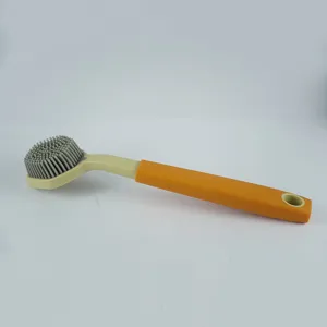 Detail shot of long-handled silicone dish brush with grey bristles and orange grip handle.