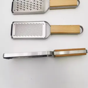 Stainless steel cheese grater with wood handle, ideal for lemon zest and chocolate.