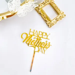 Close-up detail of golden mirror Happy Mother's Day cake topper with decorative frame.
