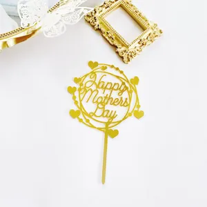 Gold acrylic Happy Mothers Day cake topper close up, decorative baking accessory detail.
