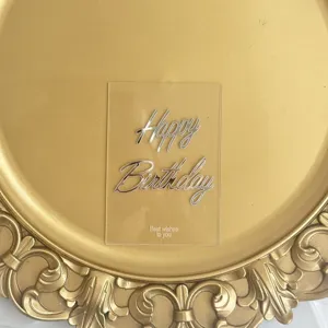 Acrylic transparent birthday cake topper detail shot showing silver Happy Birthday text.