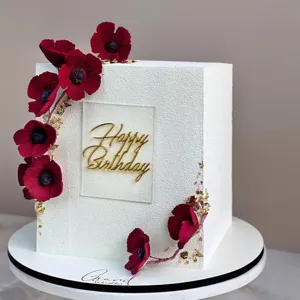 Acrylic Happy Birthday cake topper with elegant gold lettering for party decoration details.