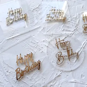 Detailed close-up view of clear acrylic happy birthday cake toppers showcasing elegant layered script.