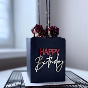 Black square birthday cake with red and silver acrylic happy birthday cake toppers.