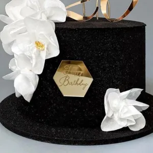 Acrylic Happy Birthday cake topper set, elegant black cake design with white floral decor.