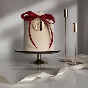 Acrylic Happy Birthday cake topper detail view, elegant gold finish with red ribbon decor.