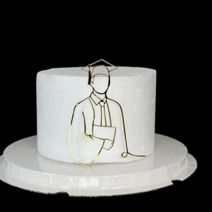 Detail view of gold acrylic graduation cake topper, minimalist silhouette design for party cakes.