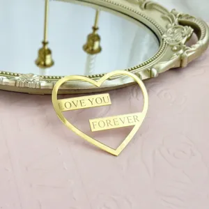 Cake topper en acrylique dore en forme de coeur, parfait pour la decoration de fete romantique.