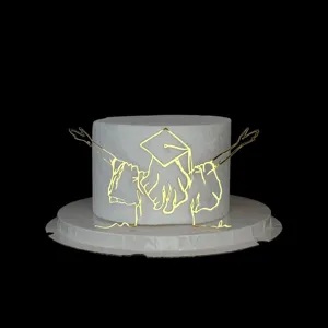 Gold acrylic graduation cake topper, elegant line art design for graduation party dessert decor.