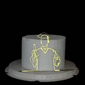 Gold acrylic graduation cake topper detail, minimalist line art graduate cake decoration view.