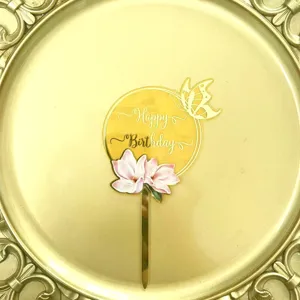 Golden acrylic happy birthday cake topper with floral and butterfly design for party celebration.
