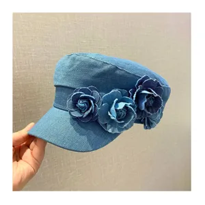 Close-up of women denim flat cap with handmade flower decoration, vintage casual style hat.