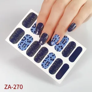 Detailed view of blue leopard print nail wraps sheet, featuring glitter dark navy stickers.